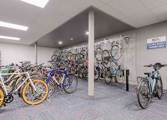 A room full of bicycles is an electric bicycle charging area.
