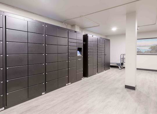 A row of black filing cabinets in a room.