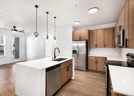 A modern kitchen with wooden cabinets and a white island.
