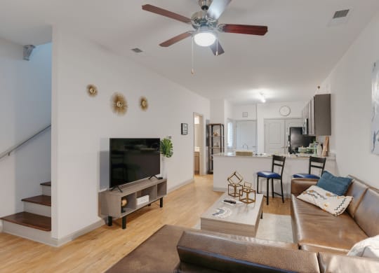 a living room with a couch and a ceiling fan