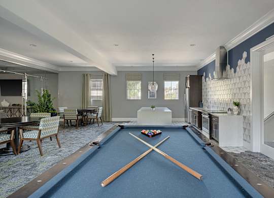 A pool table in a room with a blue cloth.