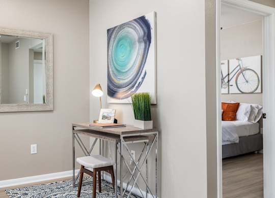A room with a desk, chair, and a painting on the wall at Clear Creek Meadows Apartments, Copperas Cove, Texas