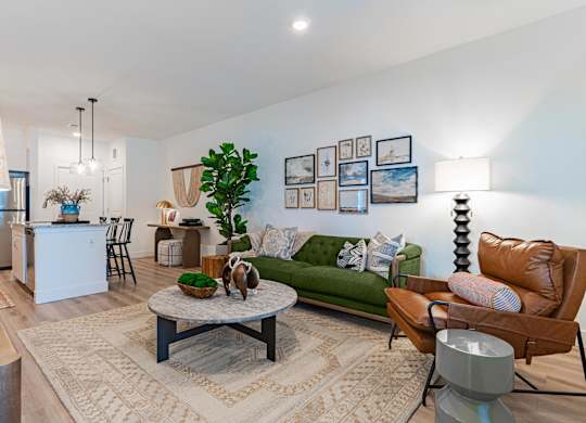 Living room with a green couch at Firestone Junction apartments for rent in Northern Colorado.