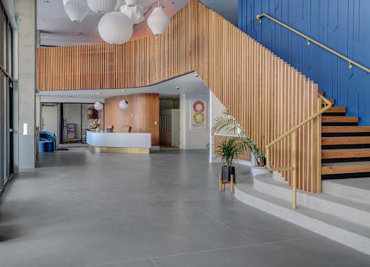 A wooden staircase with a blue wall on the side.