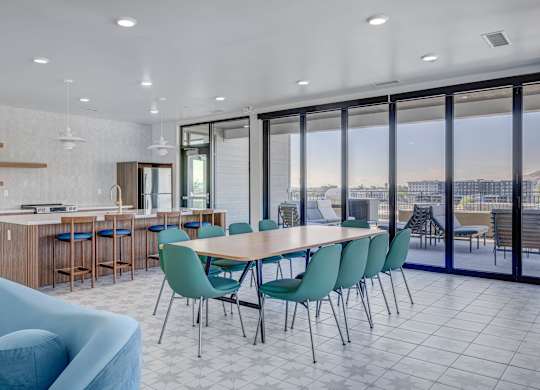 A modern dining room with a large table and chairs.