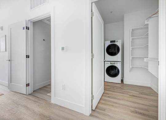 A white laundry room with a washer and dryer.