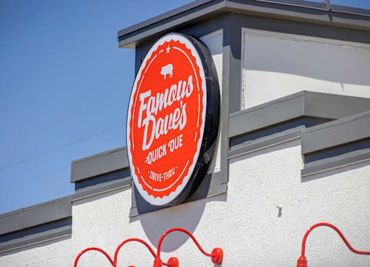 A sign for Fandango Drive-In sits on a building.