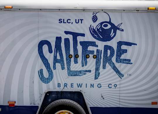 A truck with a blue fish and the words