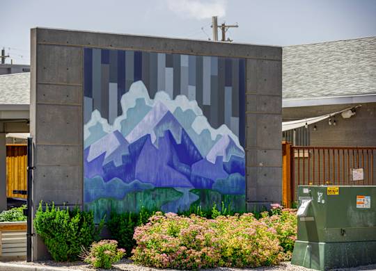 A mural of mountains painted on a wall.