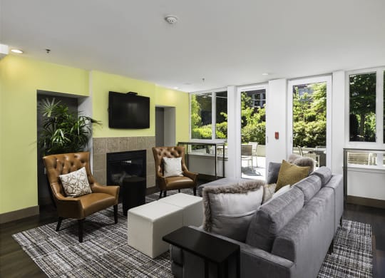 Clubhouse with lounge seating, wall tv and fireplace at Axis, Washington, 98109