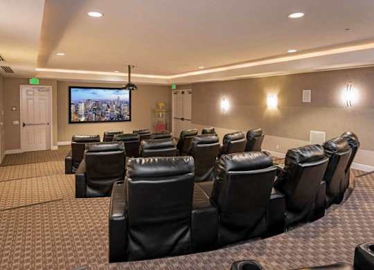 A home theater with a large screen and comfortable seating.