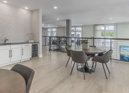 a dining room with a table and chairs and a balcony