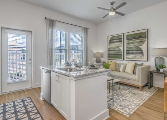an open living room with a kitchen island and a living room
