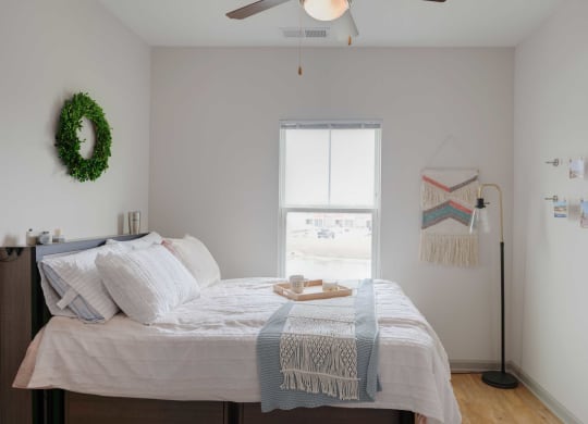 a bedroom with a bed and a window