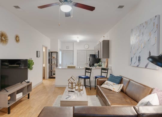 a living room with a couch and a ceiling fan