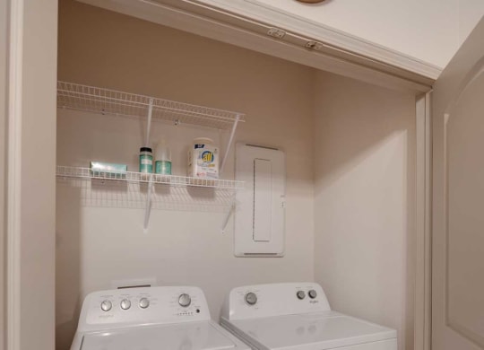 a washer and dryer in a room with a clock on the wall