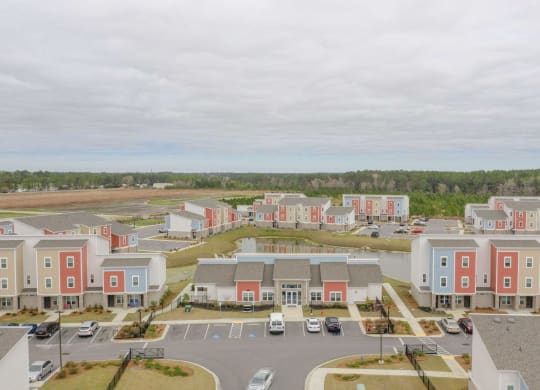 an aerial view of an apartment complex with a parking lot