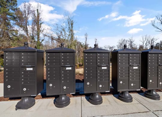 a row of mailboxes sitting on a sidewalk