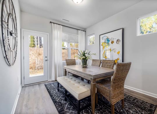 a dining room with a table and chairs and a door