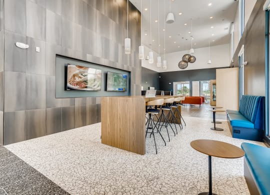 a lobby with a table and chairs and a tv
