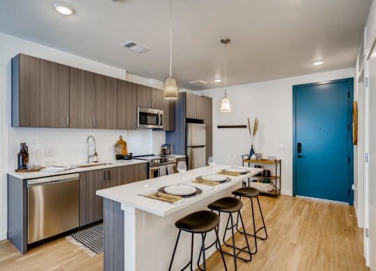 a kitchen with a long island with four stools