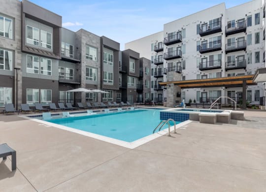 a swimming pool in front of an apartment building
