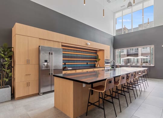 a large kitchen with a long island with chairs