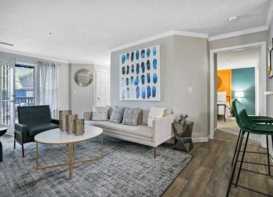 Living room with couch, chair and bar stools.