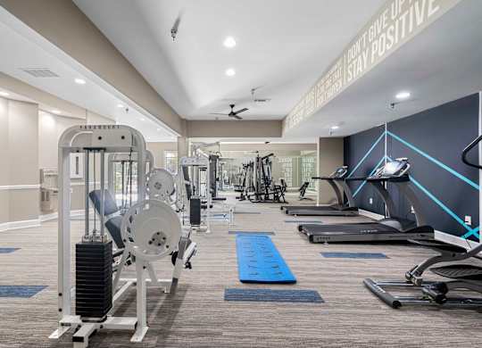 a gym with weights and cardio equipment at the estates at johnston crossing