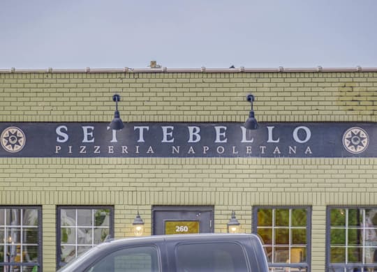 the facade of a building with a sign that reads settebello pizzeria