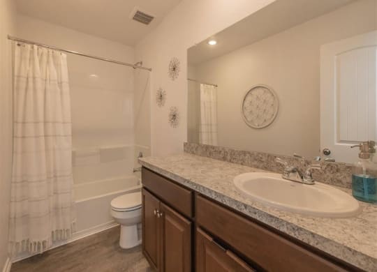 a bathroom with a sink toilet and shower at The Village at Granger Pines, Conroe Texas