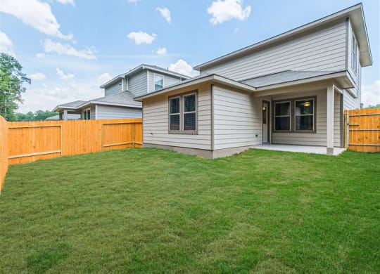 a house with a yard and a fence at The Village at Granger Pines, Conroe