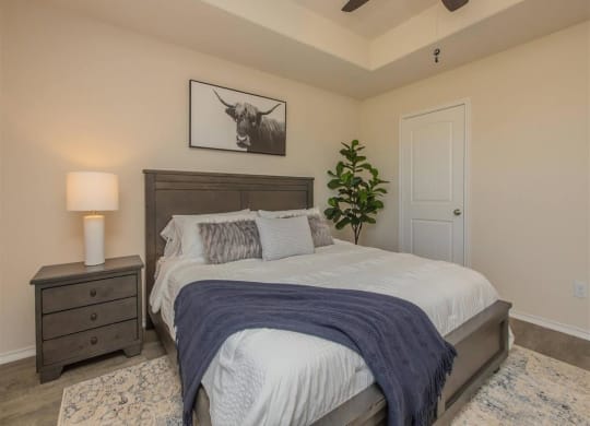 a bedroom with a bed and a ceiling fan at The Village at Granger Pines, Texas, 77302