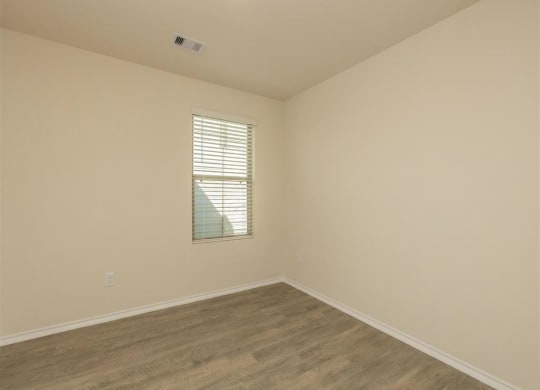 a bedroom with white walls and a window at The Village at Granger Pines, Conroe, 77302