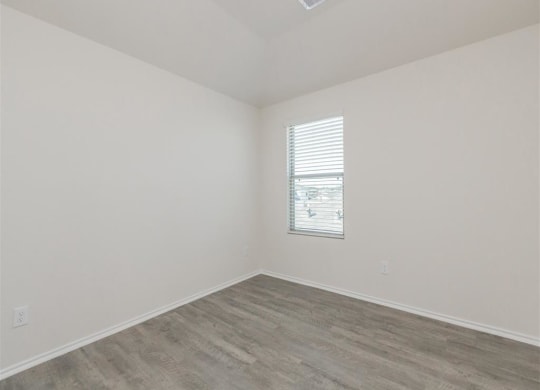 an empty room with white walls and a window at The Village at Granger Pines, Conroe, TX 77302
