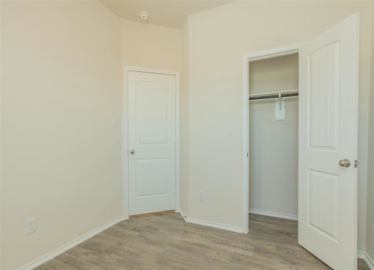a bedroom with a closet and a door to a closet at The Village at Granger Pines, Conroe, TX