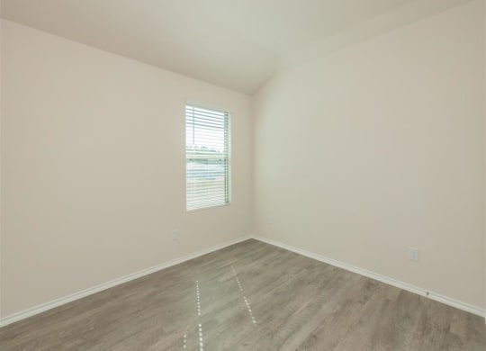 an empty room with white walls and a window at The Village at Granger Pines, Conroe, TX 77302