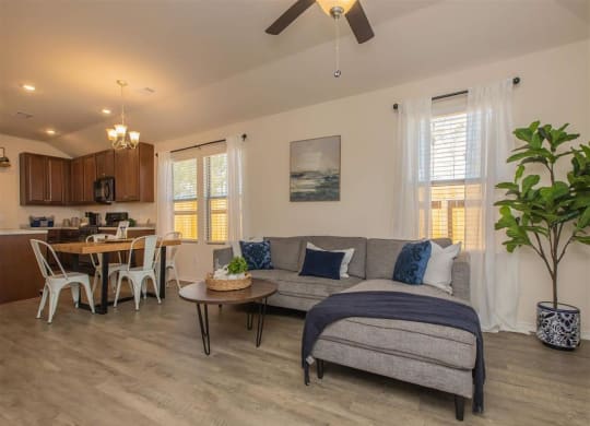 a living room with a couch and a table at The Village at Granger Pines, Texas, 77302