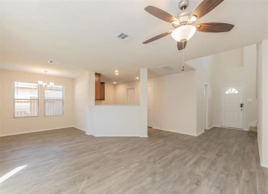 an empty living room with a ceiling fan at The Village at Granger Pines, Conroe, TX 77302