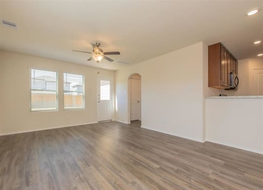 an empty living room with a ceiling fan at The Village at Granger Pines, Texas, 77302