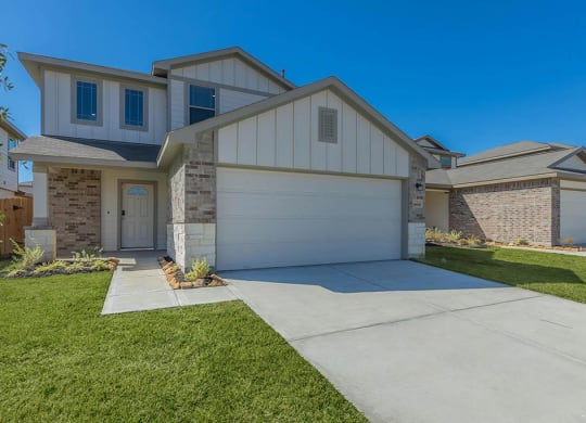 a home with a white garage door at The Village at Granger Pines, Conroe