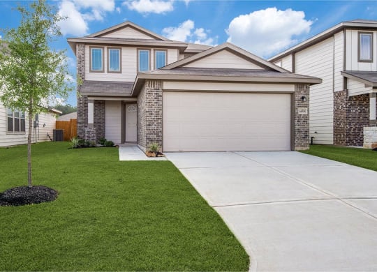 a house with a driveway in front of it at The Village at Caney Mills, Conroe