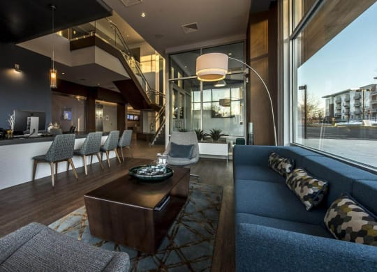 a large living room with a blue couch and a coffee table
