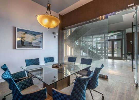a conference room with a glass table and chairs