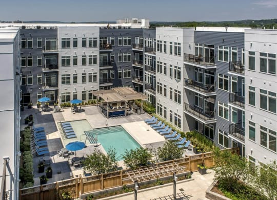 an aerial view of an apartment building with a swimming pool