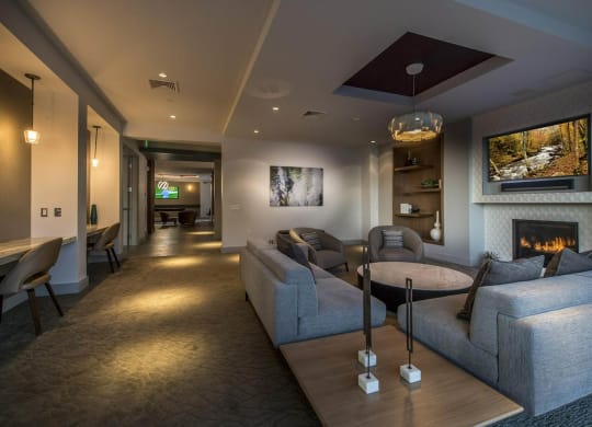 a living room with couches and a table and a fireplace