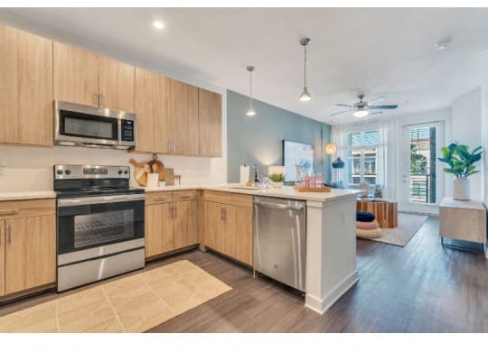 a large kitchen with stainless steel appliances and wooden cabinets