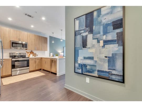 a painting hanging in a kitchen next to a