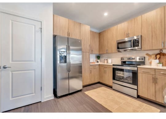 a kitchen with stainless steel appliances and a refrigerator