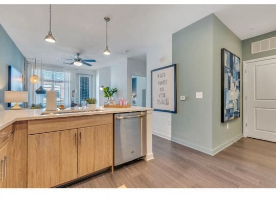 a kitchen with an island and a ceiling fan